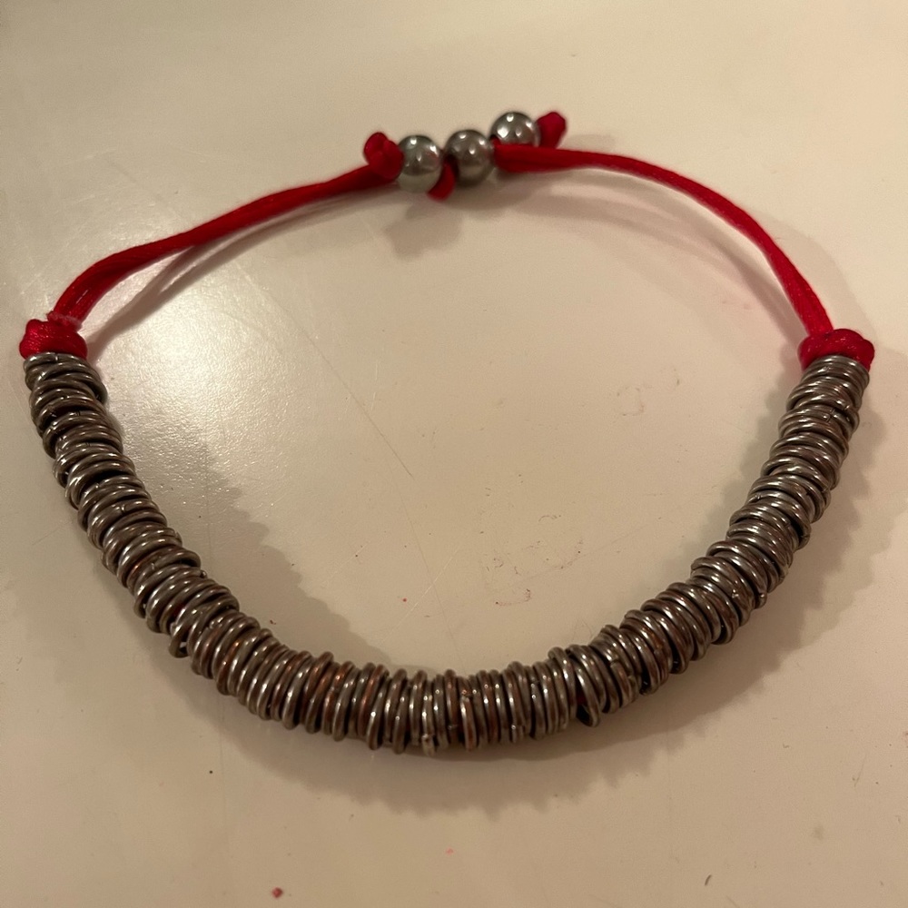 Silver coloured links on red string - Picture 2 of 4